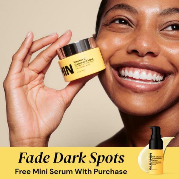 A close-up photograph of a smiling user holding a Vitamin C Treatment Mask, paired with a clear offer for a free mini serum to incentivize purchase.
